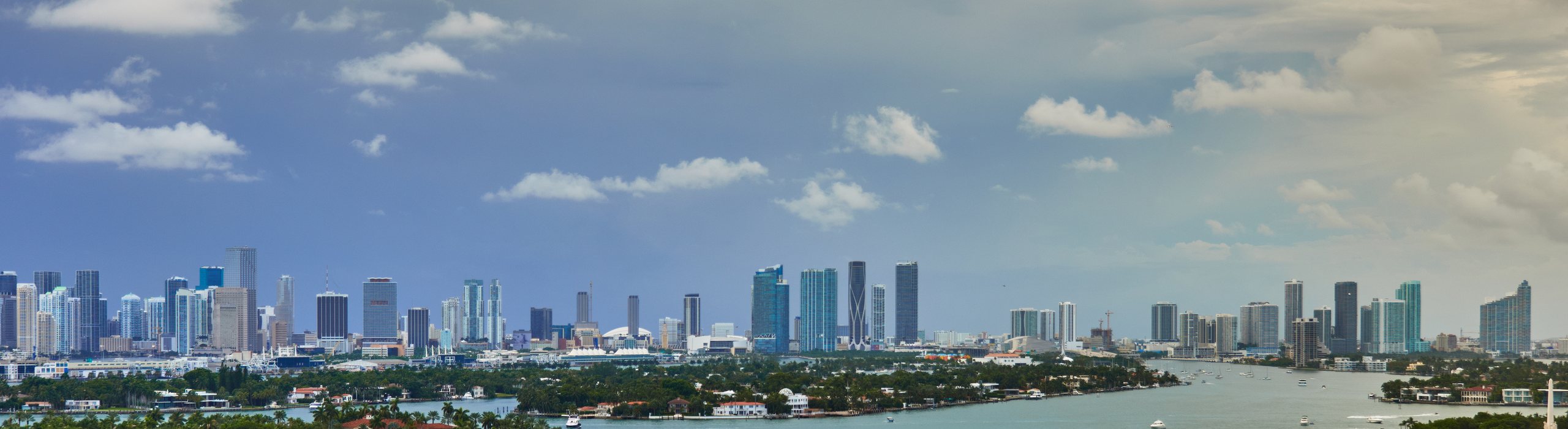 Aerial view of the Miami skyline and Biscayne Bay with islands and boats